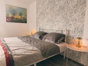 a bed in a bedroom with two side tables at Plate lyn atostogų būstas in Plateliai