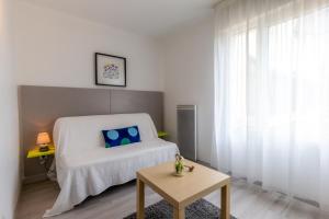 Postel nebo postele na pokoji v ubytování Sphinx Résidences - Les Doges / Le Rialto