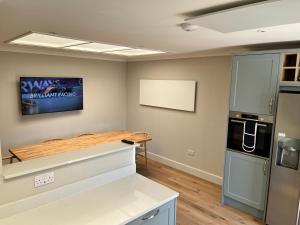 a kitchen with a counter top and a refrigerator at Dune House, Golf Road, Dornoch 5x Bedrooms in Dornoch