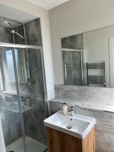 a bathroom with a sink and a shower at Dune House, Golf Road, Dornoch in Dornoch +29 photos