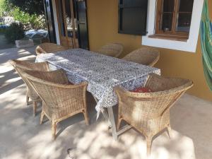 a table with wicker chairs and a table with a table cloth at Cas Conco in Ciutadella +35 photos