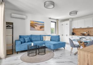 a living room with a blue couch and a table at SEA SHELL Apartment in Sozopol