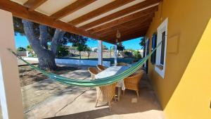a hammock on the porch of a house at Cas Conco in Ciutadella