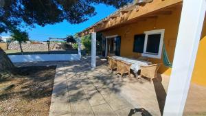 a patio with a table and chairs next to a house at Cas Conco in Ciutadella