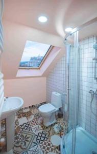 a bathroom with a shower and a toilet and a sink at Rooftop Apartments at Rustaveli Avenue in Tbilisi City