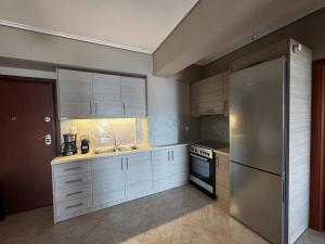 a kitchen with a stainless steel refrigerator and a sink at Amfithea in Amfilochia