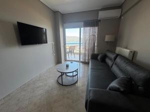 a living room with a couch and a table at Amfithea in Amfilochia