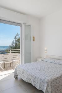 Postel nebo postele na pokoji v ubytování Hotel Flora