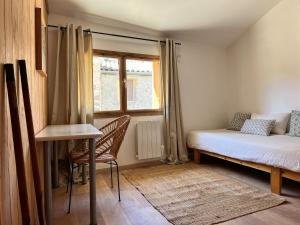 a small bedroom with a bed and a window at YouMe, petit nid douillet in Aumessas
