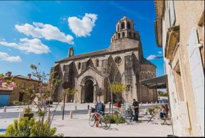 an old church with bikes parked in front of it at La Rêverie in Le Thor