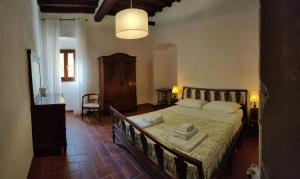 a bedroom with a large bed with towels on it at I Giardini di Marcello in Dicomano +84 photos