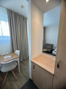 a room with a desk and a table with a chair at bookVienna "Paula" Apartments in Vienna +88 photos