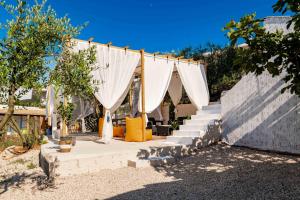 a set up for a wedding with white curtains at Vila Eden in Ksamil