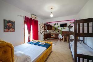 a bedroom with a bed and a bunk bed at Vila Eden in Ksamil
