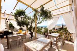 a restaurant with tables and chairs and a view at Vila Eden in Ksamil
