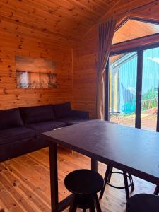 a living room with a table and a couch at Ada Bojana Beach House I XXL TerraceI BBQ I Betw BridgeBeach I Air Con in Ulcinj