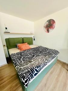 a bedroom with a bed with a black and white comforter at Business Apartment Karlsruhe Südwest in Karlsruhe