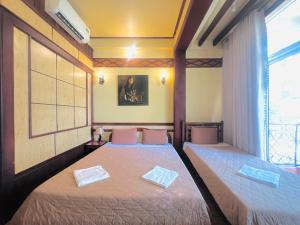 Postel nebo postele na pokoji v ubytování BI SAIGON Hotel - BUI VIEN WALKING STREET