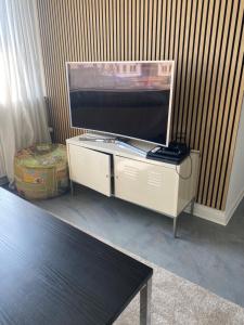 a flat screen tv sitting on top of a cabinet at The old bank in Sønderborg