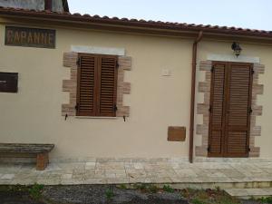 two shutters on the side of a building at Casetta Capanne in Capanne