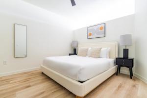 a white bedroom with a white bed and a table at Blueground Round Rock pool nr Old Settlers Park ATX-318 in Austin +21 photos