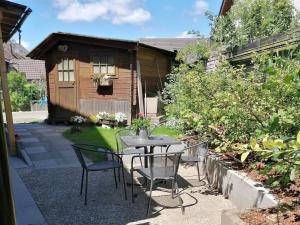 a patio with a table and chairs in front of a house at Jogis Ferienwohnungen in Freiburg im Breisgau