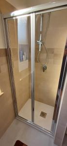 a shower with a glass door in a bathroom at Angela apartments in Partinico +26 photos