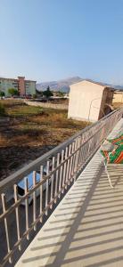 a white boardwalk with a fence on top of a building at Angela apartments in Partinico