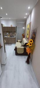 a bedroom with a bed with flowers on the wall at Angela apartments in Partinico