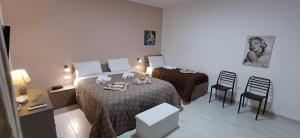 a hotel room with a bed and a table and chairs at Angela apartments in Partinico