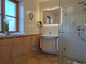 a bathroom with a sink and a shower at Ferienhof Haug in Rieden am Forggensee +39 photos