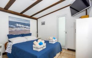 a bedroom with a blue bed with a painting on the wall at Casa Silente Opatija by Villas Guide in Lovran
