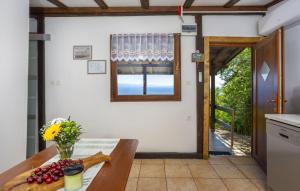 a kitchen with a table and a window and a door at Casa Silente Opatija by Villas Guide in Lovran