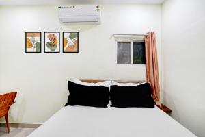 Un dormitorio con una cama blanca y una ventana. en Hotel O Century grand luxury rooms, en Warangal