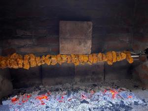 a bunch of food is cooking on a grill at Brvnara "Duboki Potok" in Vrnjačka Banja