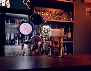 a glass of beer sitting on top of a bar at Hotel Metsähirvas in Rovaniemi +42 photos