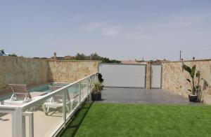 a balcony with a pool and a lawn at Casa el rincon de la Rosa II in Conil de la Frontera
