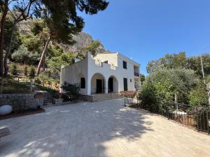 a white house with a driveway in front of it at Villa Rubino Mondello Guest house - By Rentalbeb Italy in Palermo