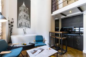 a bathroom with a tub and a table and chairs at DeZign Superior Apartments & Rooms in Zadar