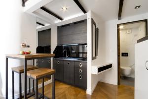 a kitchen with black cabinets and a counter top at DeZign Superior Apartments & Rooms in Zadar