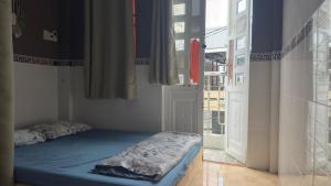 a room with a bed in a room with a window at Lam NguyenVn Minihouse in Can Tho