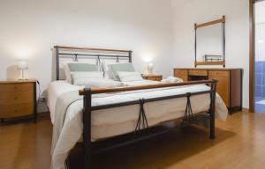 a bedroom with a bed and a mirror on the wall at Slowing Villas - Villa Oceano in Porto Santo