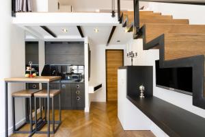 a kitchen with a kitchen island and a staircase at DeZign Superior Apartments & Rooms in Zadar
