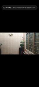 a picture of a bathroom with a window and a plant at Taman Mas Falim in Gua Sai
