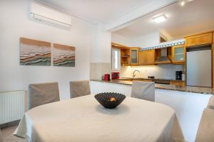 a kitchen with a table with a bowl on it at Garden' s Villa in Agioi Theodoroi