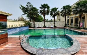 a swimming pool in the middle of a house at Pinaka Hotels & Resorts in Haridwār