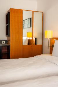 a hotel room with a bed and a mirror at CHR Vista in Nicoreşti