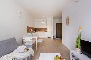 a living room with a couch and a table at ShortStayPoland Sokratesa in Warsaw