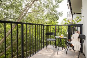 a balcony with a table and chairs and a tree at ShortStayPoland Sokratesa in Warsaw
