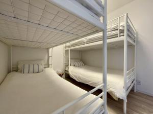 two bunk beds in a room with white walls at Hayama Morito Beach Seascape Villa - 葉山 森戸海岸 Seascape Villa in Hayama